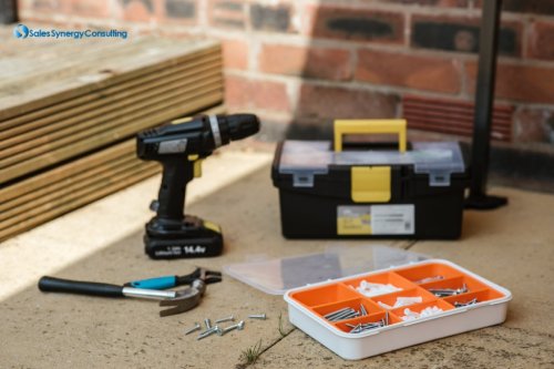 A drill and two tool boxes on the floor